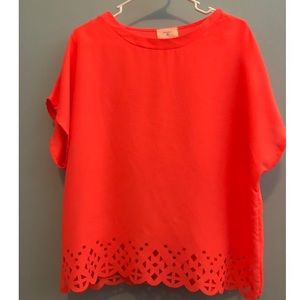 Neon coral shirt with cutouts on the botttom